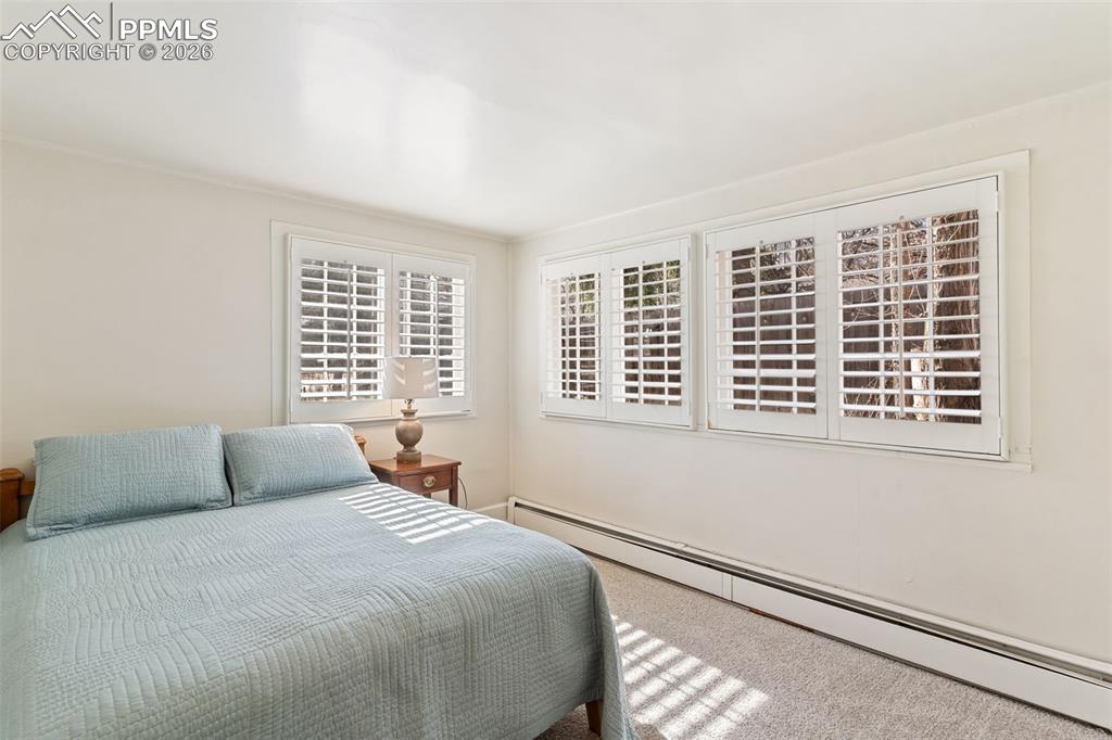 Image 25 of 36: Second bedroom is bathed in natural light, and has built in closets.