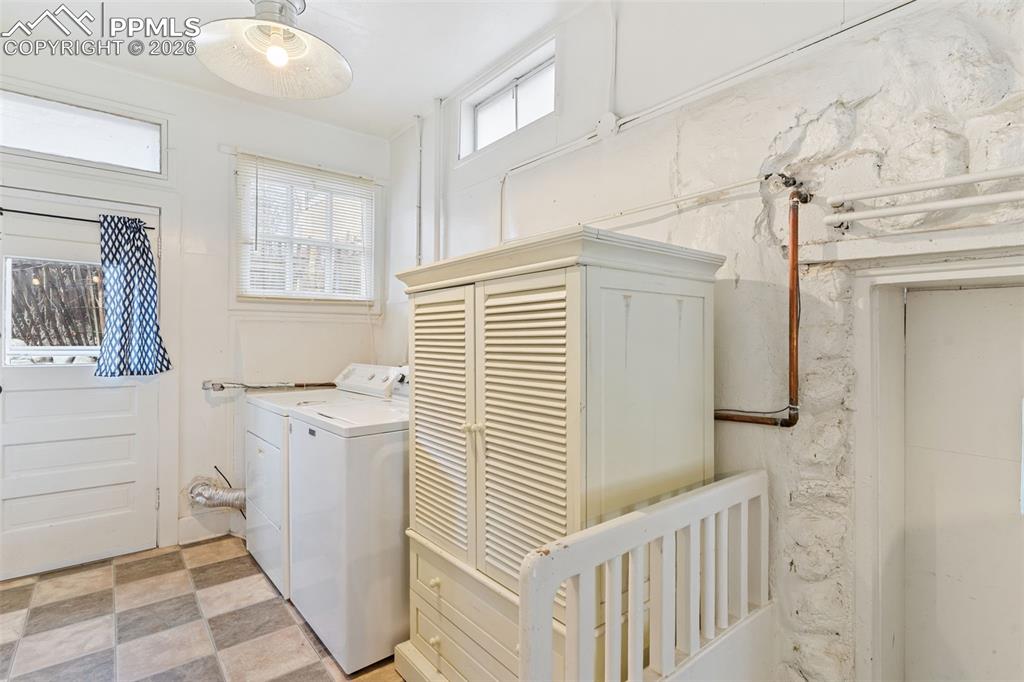 Image 26 of 36: Laundry is right off the kitchen and has a lot of natural light; door to ou