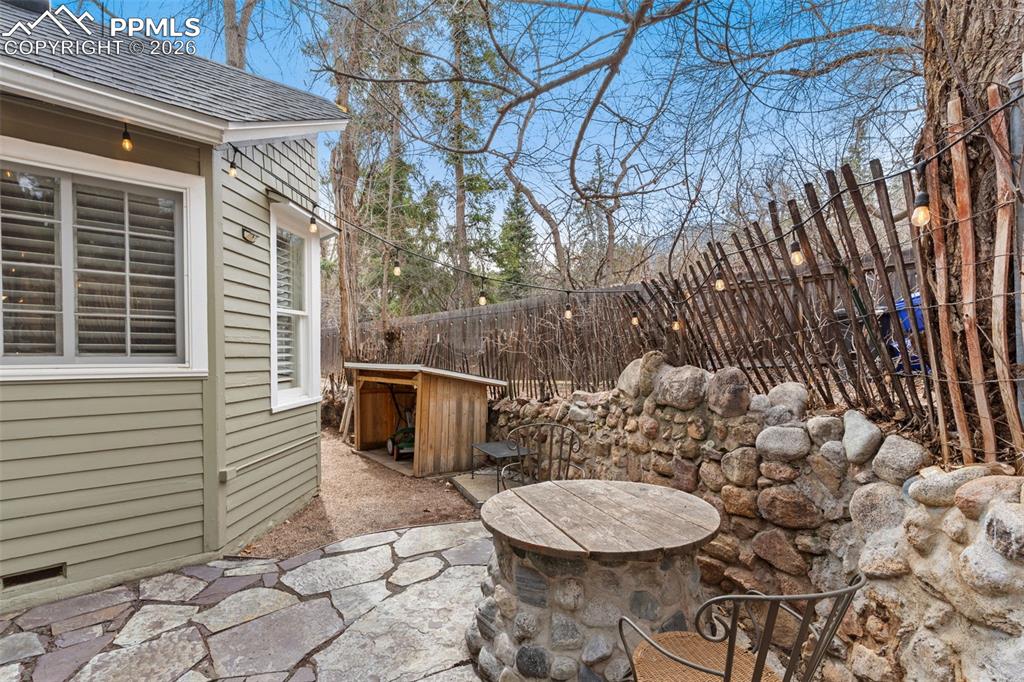Image 31 of 36: Side patio, with beautiful pavers, is off the kitchen and laundry room and
