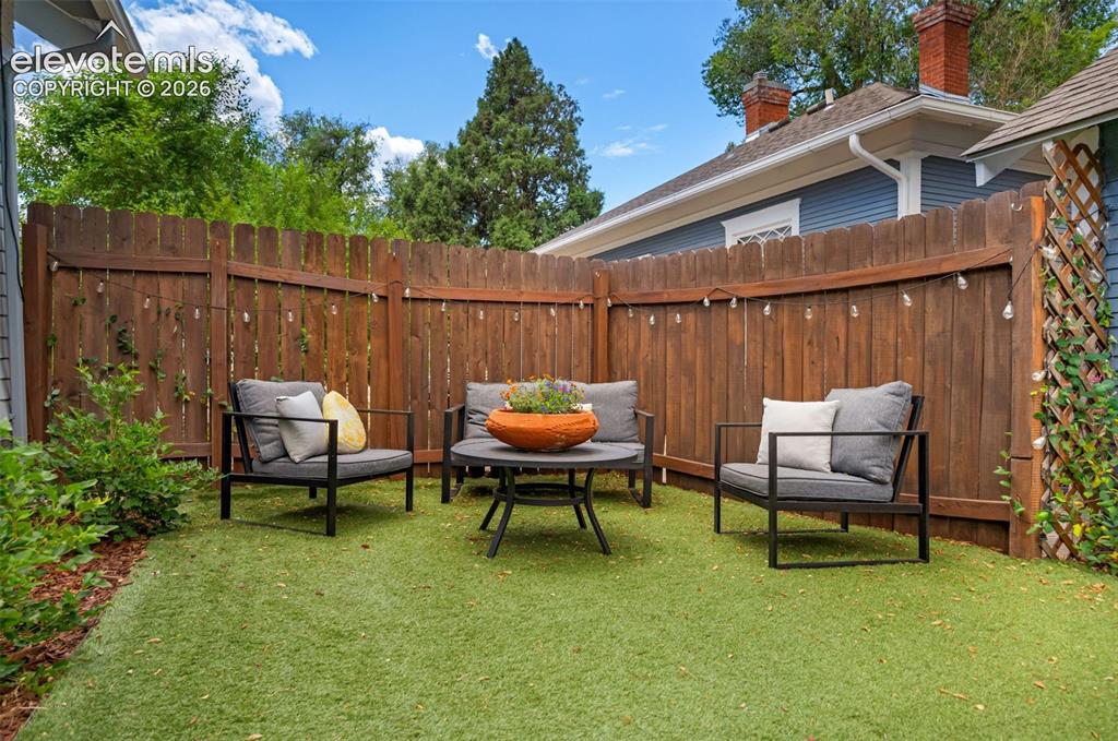 Image 42 of 50: Long turf, fenced in side yard