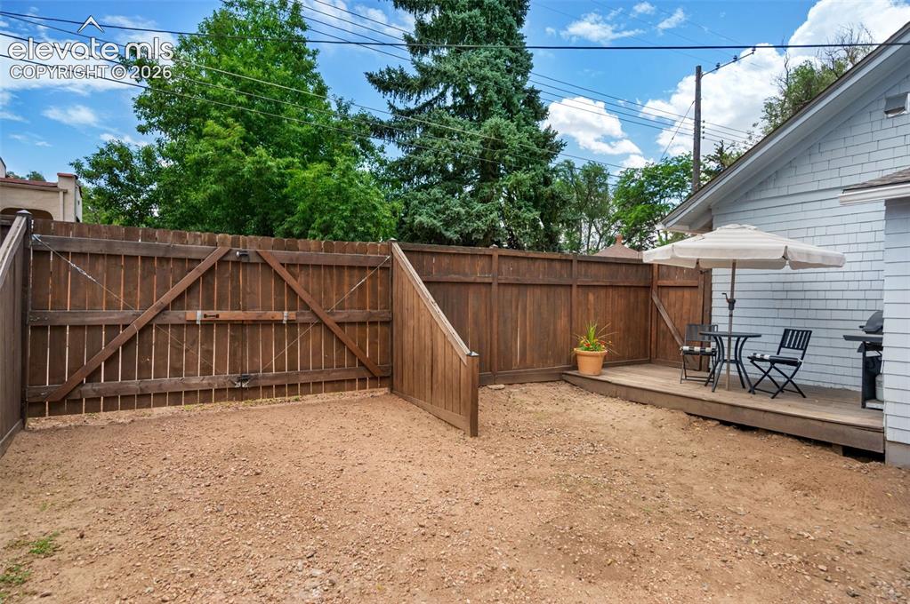 Image 46 of 50: Manual, locked gate off alley