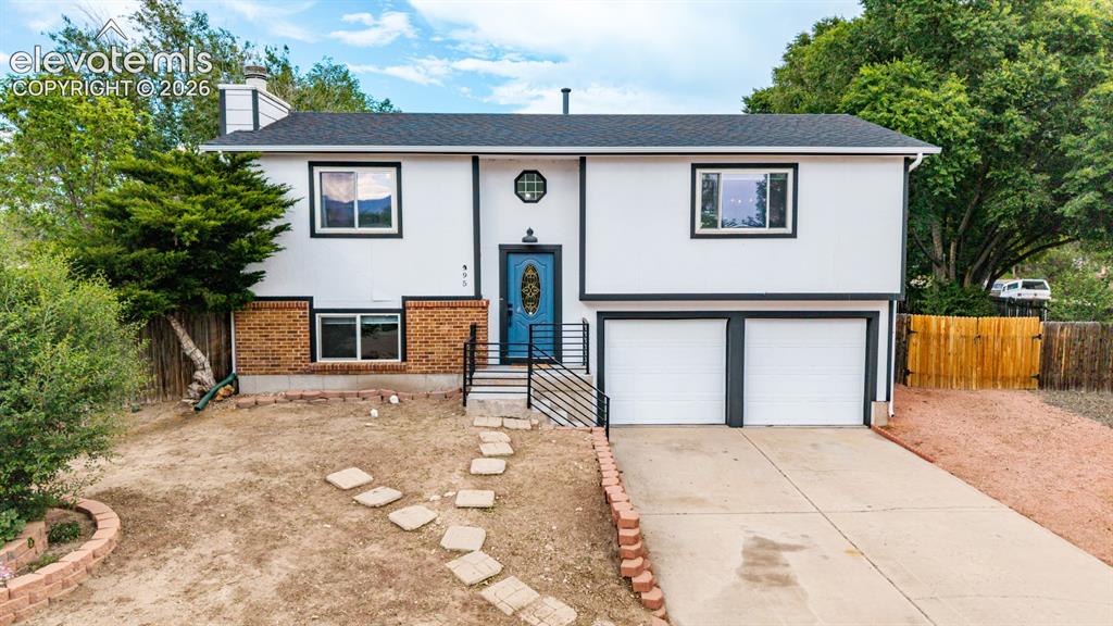 Image 1 of 44: Contemporary split-level residence featuring a two-car garage, new roof and
