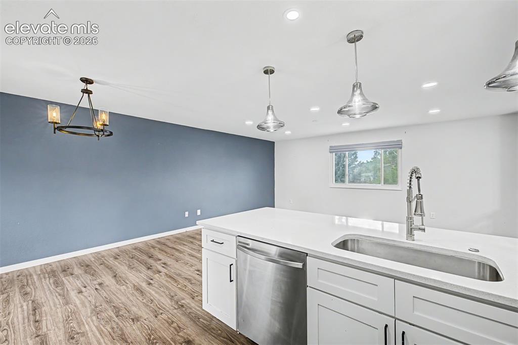 Image 10 of 44: Kitchen island featuring an undermount stainless steel sink with a goosenec