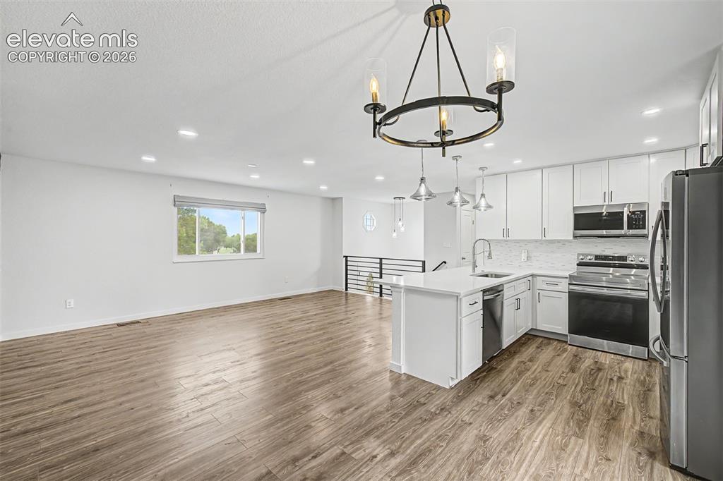 Image 11 of 44: Open-concept kitchen/dining/living room allows for easy entertaining or qui