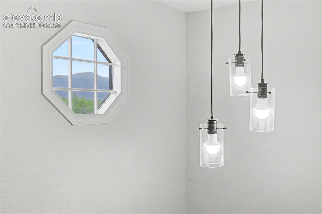 Image 19 of 44: Grand foyer offers lots of natural light and a glimpse of Pikes Peak as you