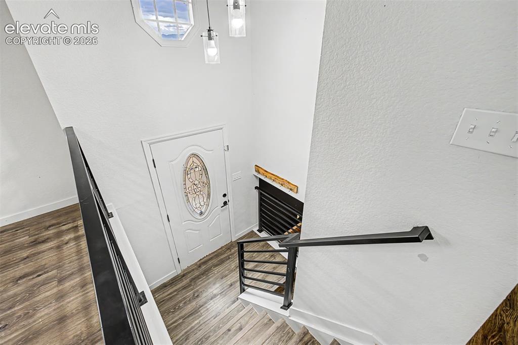 Image 20 of 44: Grand foyer offers lots of natural light and opens to the lower level. 