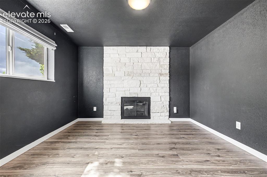 Image 22 of 44: Wood burning stone fireplace is lovely on cold Colorado evenings. 