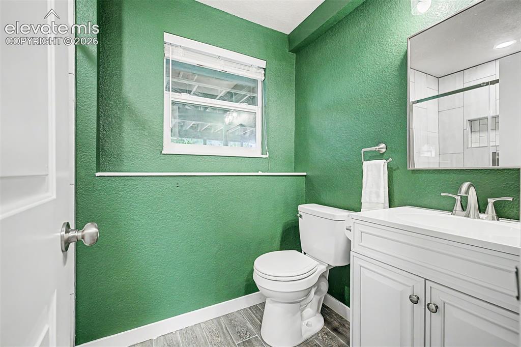 Image 27 of 44: Bathroom featuring a white vanity with cabinet storage, white countertop, a