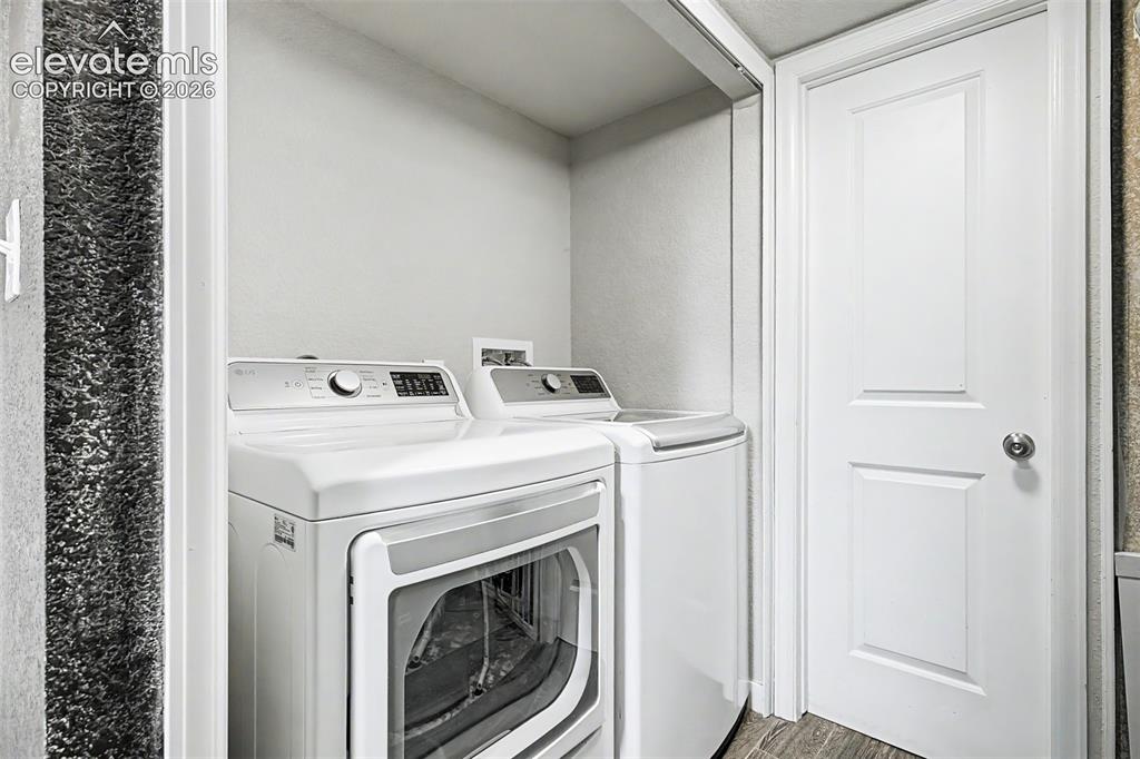 Image 29 of 44: Dedicated laundry space featuring a newer washer and dryer that stay with t