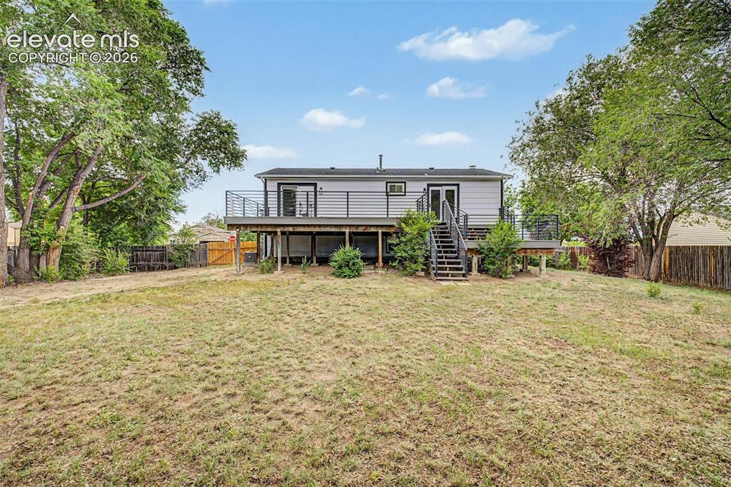 Image 37 of 44: Imagine your next BBQ on this deck watching friends play horseshoes or corn