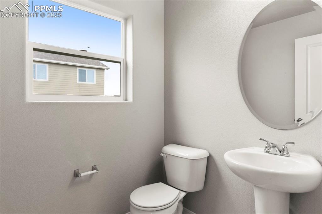 Image 13 of 22: Half bath featuring a textured wall