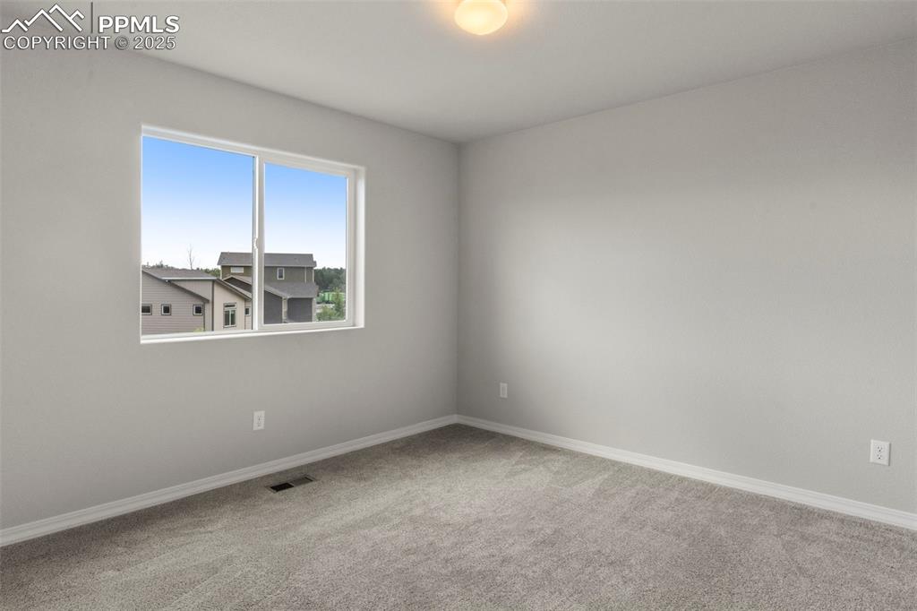 Image 16 of 22: Spare room featuring carpet floors and baseboards