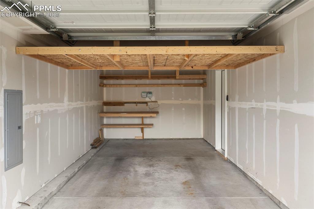 Image 20 of 22: Garage featuring electric panel