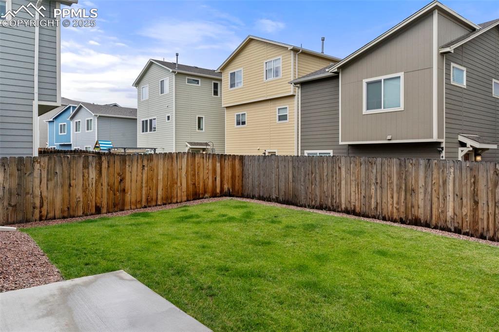 Image 21 of 22: Fenced backyard featuring a residential view