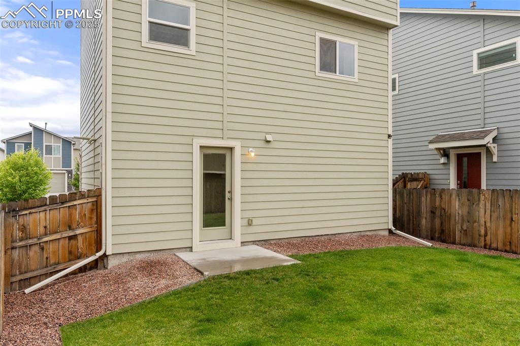 Image 22 of 22: Back of house with a fenced backyard