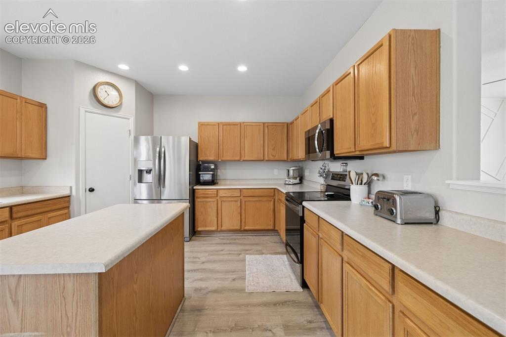 Image 10 of 43: Large kitchen with center island and walk-in pantry