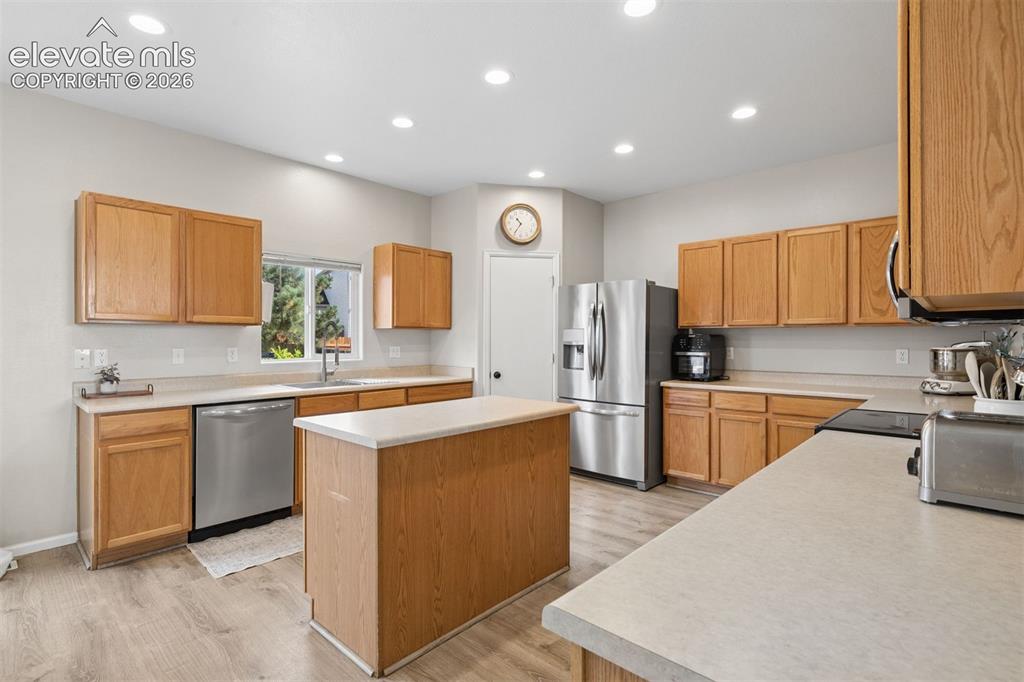 Image 11 of 43: Large kitchen with center island and walk-in pantry