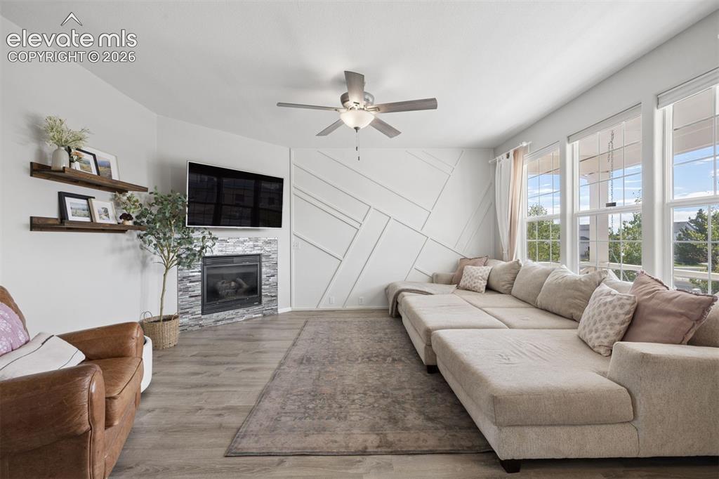 Image 15 of 43: Inviting living room with LVP floor and fireplace