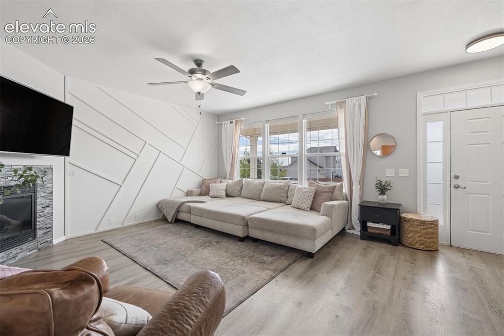 Image 16 of 43: Inviting living room with LVP floor and fireplace