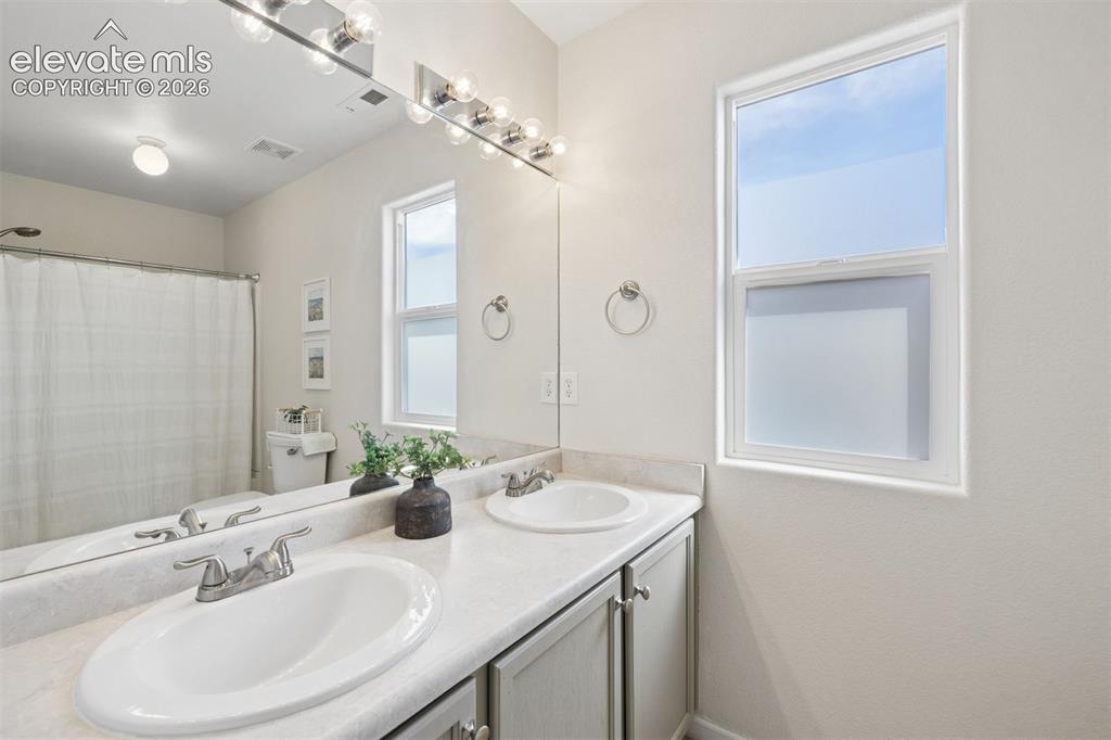 Image 17 of 43: Primary ensuite bathroom with dual sink vanity
