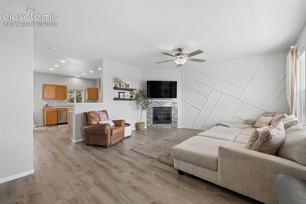 Image 2 of 43: Welcoming living room with LVP floor and fireplace