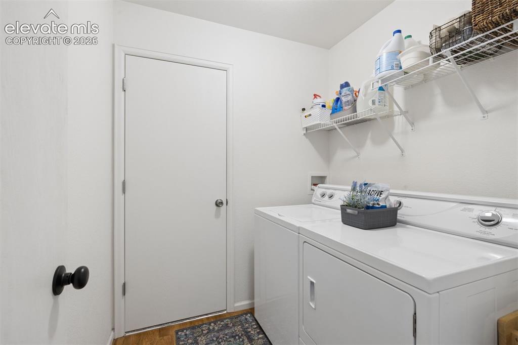 Image 22 of 43: Upper level laundry room with a dedicated storage closet (7x4), shelves, an