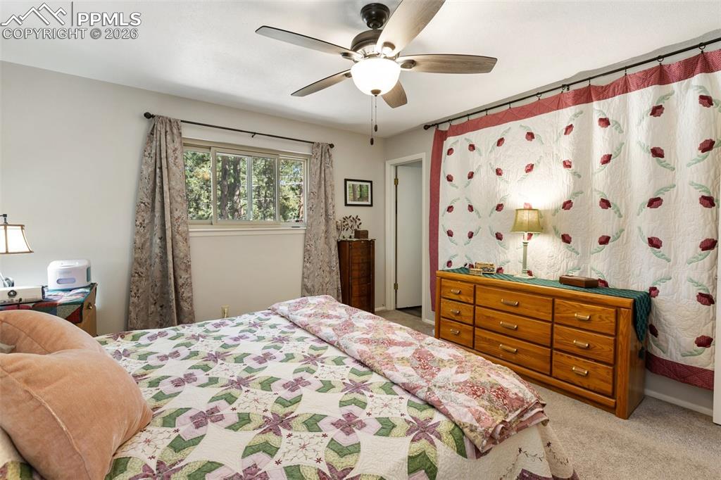 Image 22 of 36: Bedroom featuring a ceiling fan and light colored carpet