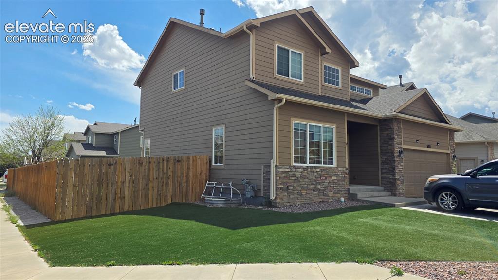 Image 1 of 35: Contemporary two-story residence featuring a two-car garage, stone and sidi