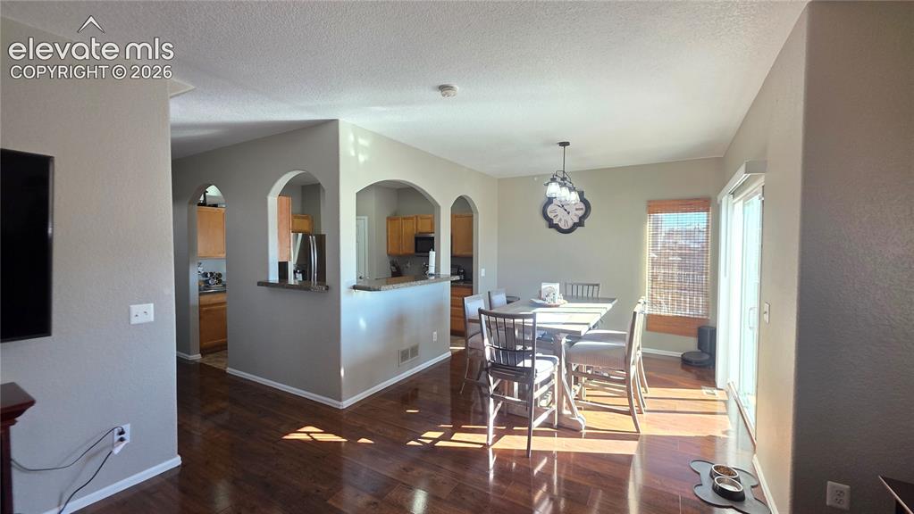 Image 11 of 35: Open concept living space featuring wood-finish flooring