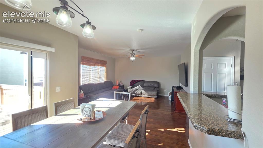 Image 12 of 35: Open-concept living space featuring wood-finish flooring, a sliding glass d
