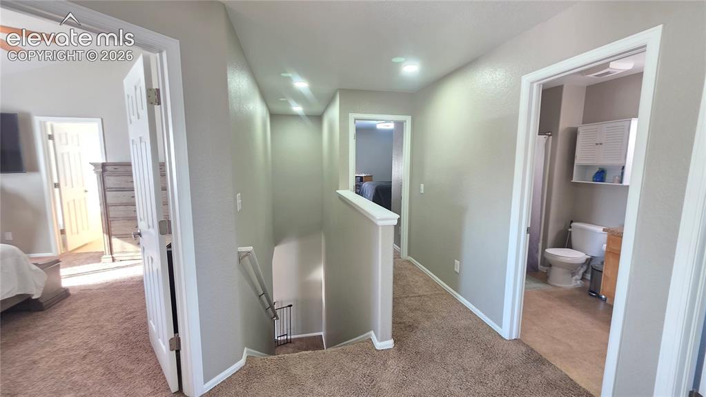 Image 20 of 35: Upper-level hallway featuring recessed lighting, a neutral color palette, a