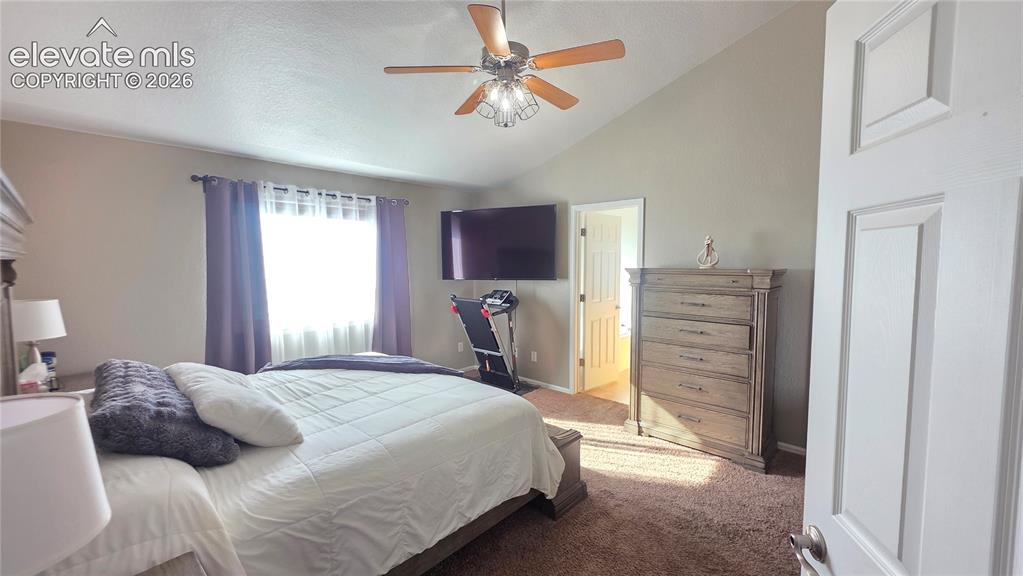 Image 21 of 35: Vaulted ceiling room featuring a ceiling fan with integrated lighting, a wi