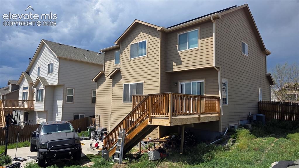 Image 3 of 35: Multi-level exterior with tan siding and white trim