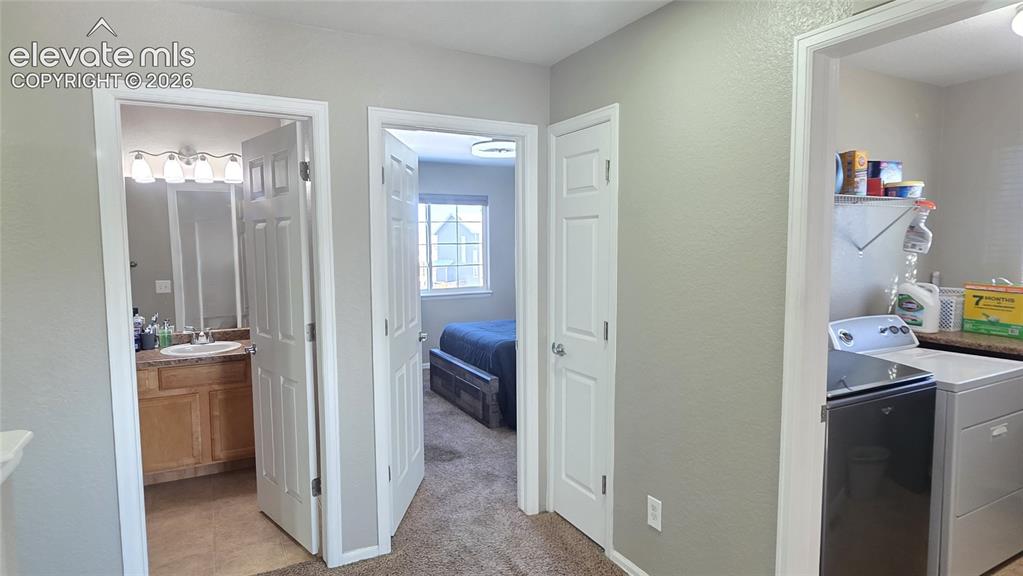 Image 30 of 35: Central hallway with neutral wall tones and white trim