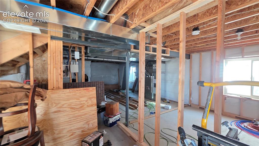 Image 33 of 35: Framed interior space featuring exposed ceiling joists, visible HVAC ductwo