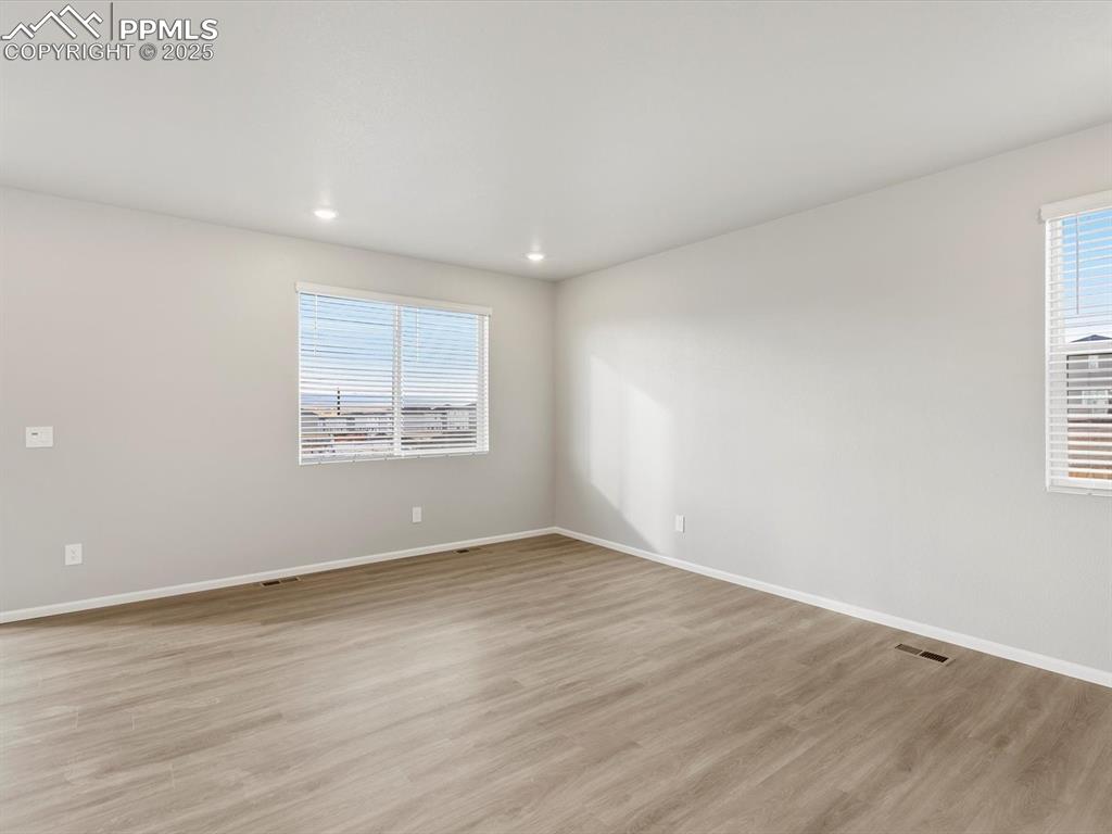 Image 11 of 25: Spare room featuring light wood-type flooring and recessed lighting