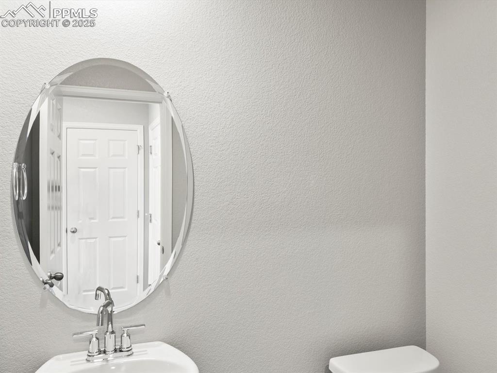 Image 12 of 25: Bathroom with a textured wall and a sink