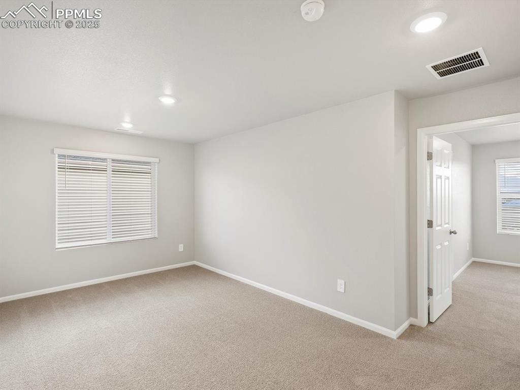 Image 14 of 25: Spare room with light carpet and recessed lighting