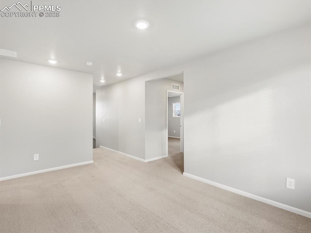 Image 15 of 25: Carpeted empty room with baseboards and recessed lighting