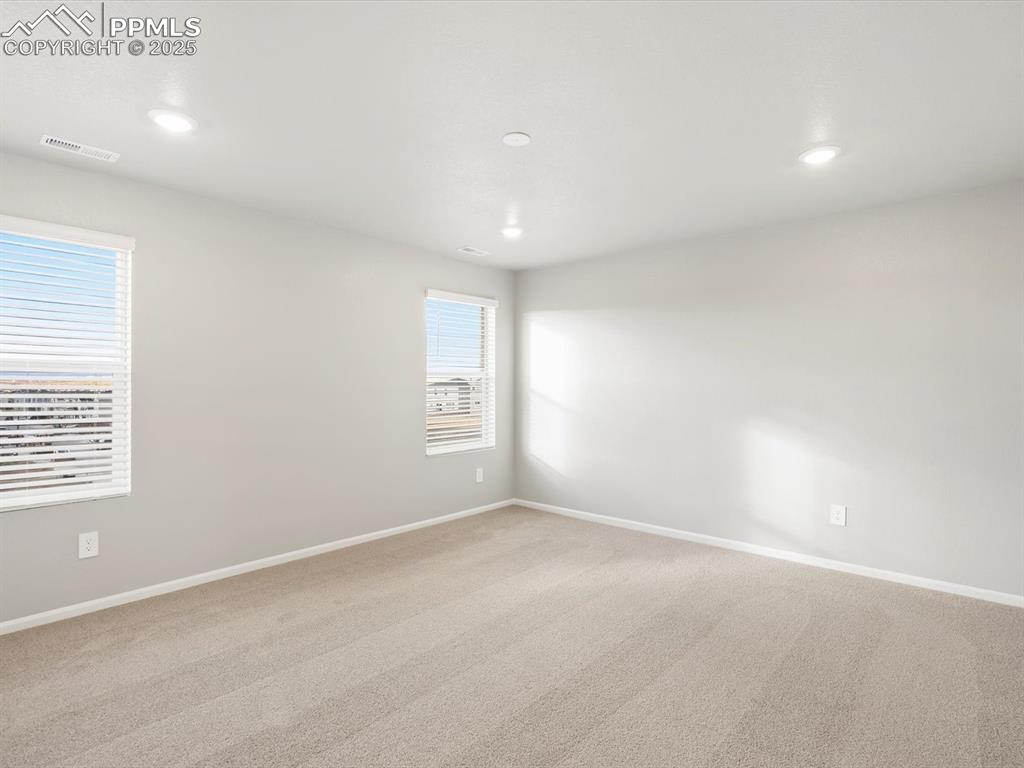 Image 16 of 25: Carpeted empty room with baseboards and recessed lighting