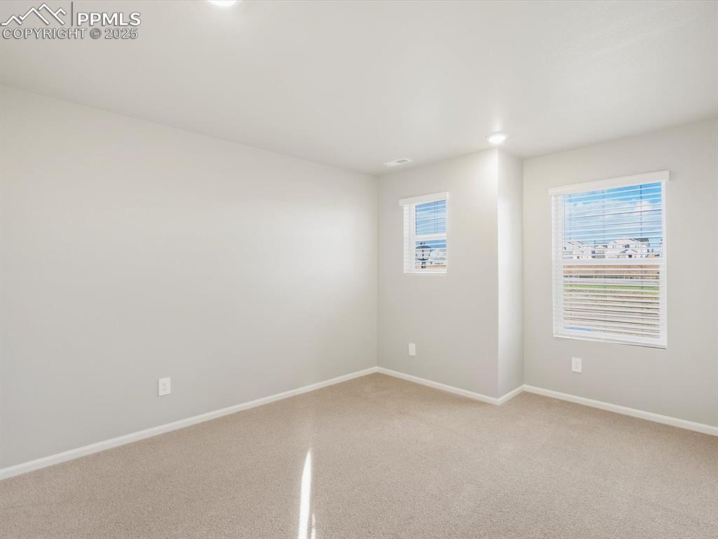 Image 22 of 25: Carpeted spare room with baseboards and recessed lighting