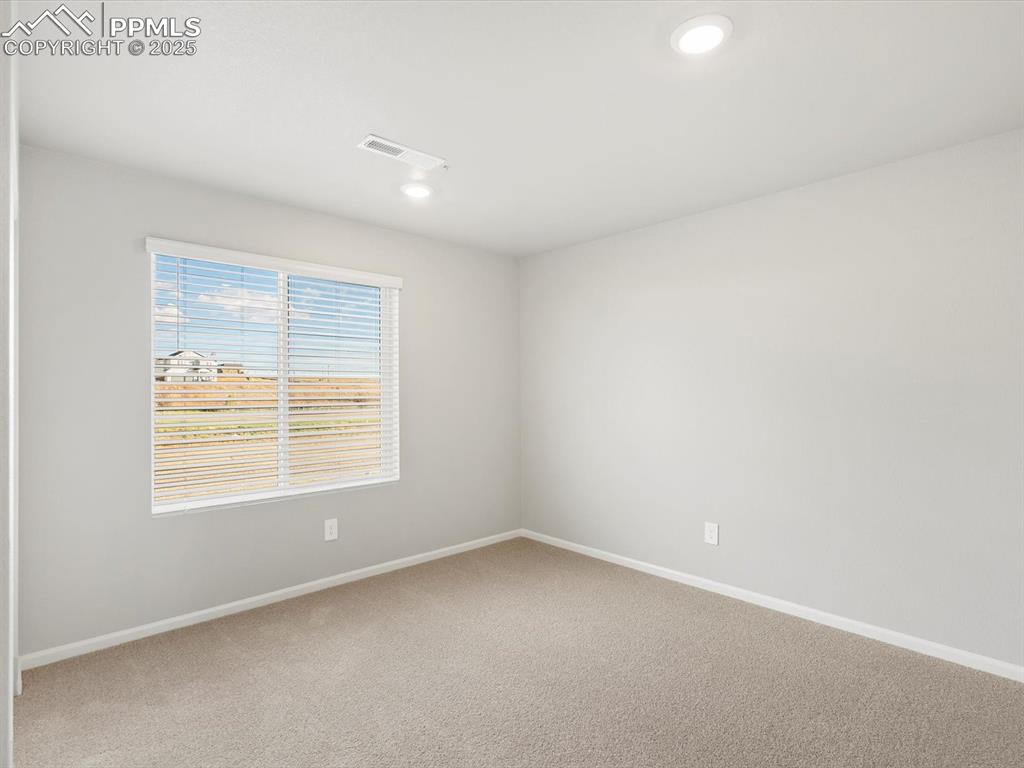 Image 23 of 25: Spare room with carpet floors and recessed lighting