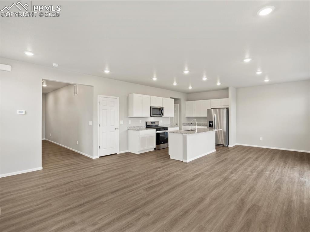 Image 9 of 25: Kitchen featuring appliances with stainless steel finishes, open floor plan