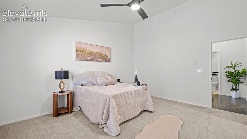 Image 20 of 46: Carpeted room featuring a vaulted ceiling and a ceiling fan