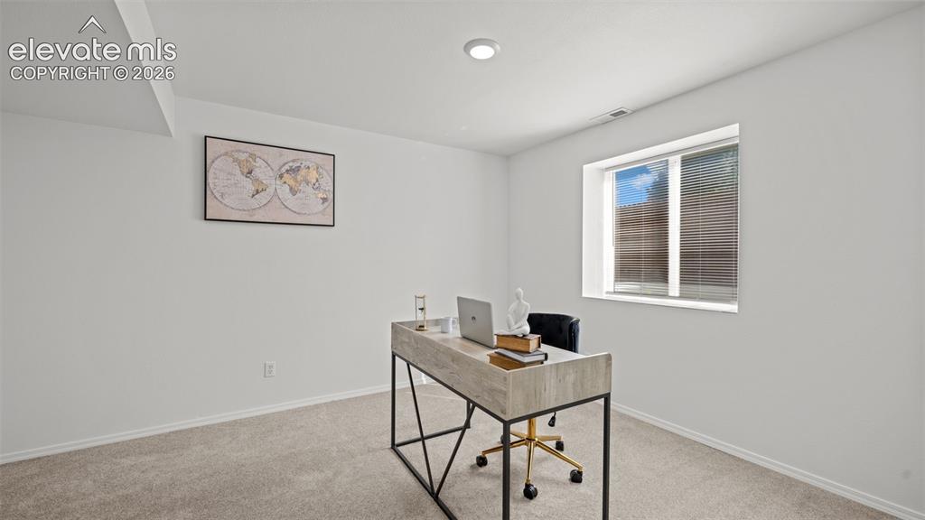 Image 28 of 46: Room featuring a window with integrated blinds, recessed lighting, and neut
