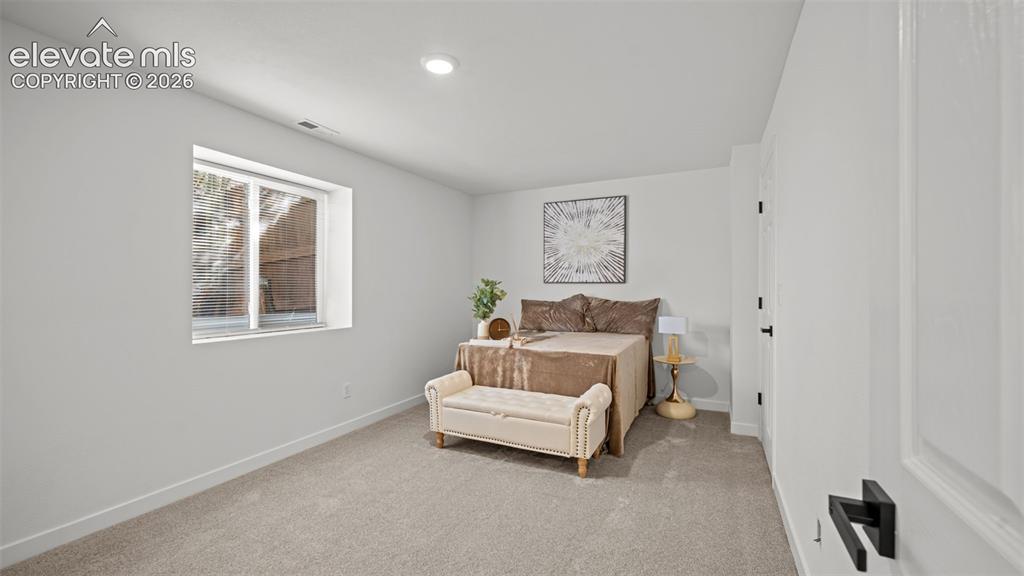 Image 30 of 46: Spacious room featuring light gray carpeting, recessed ceiling lighting, a