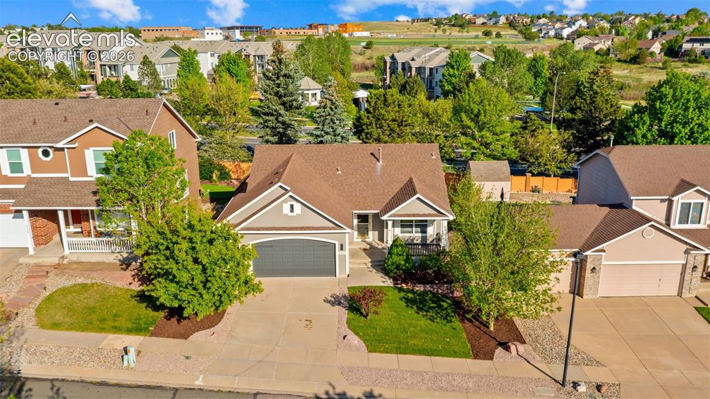 Image 36 of 46: Single-story residence featuring a two-car garage, front porch, and mature