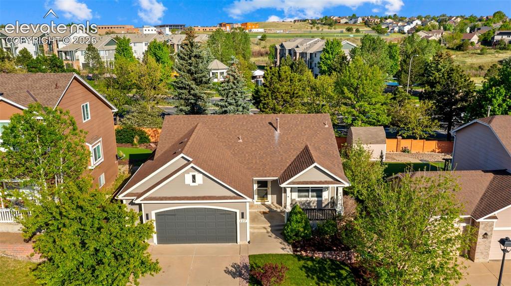 Image 39 of 46: Traditional-style residence featuring a two-car garage, pitched roof, and m