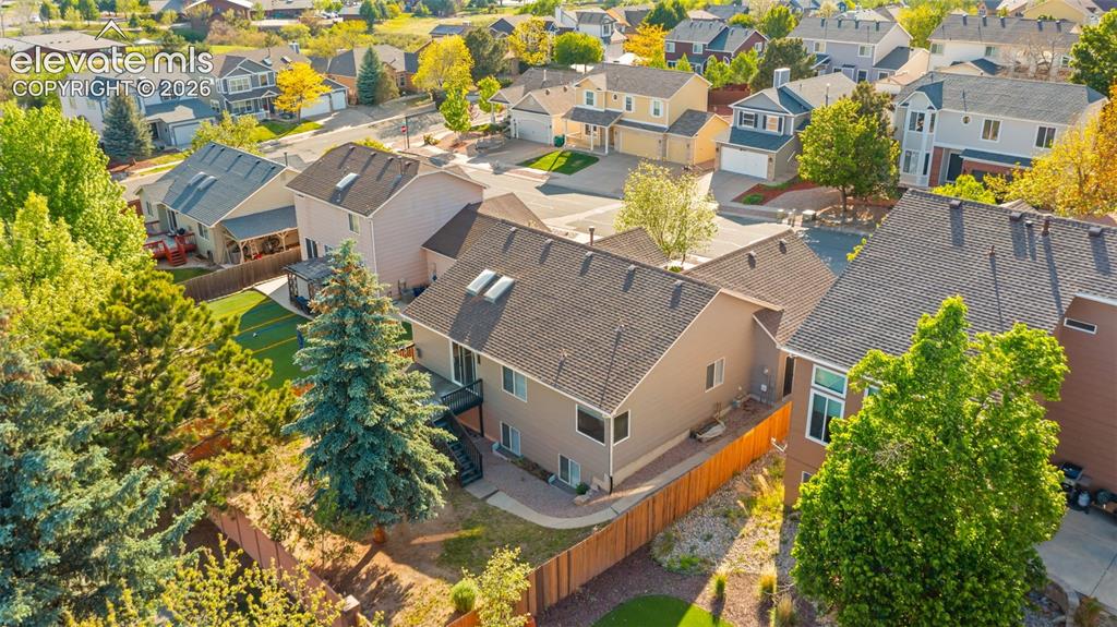 Image 40 of 46: Suburban residential setting featuring multiple detached homes with varying
