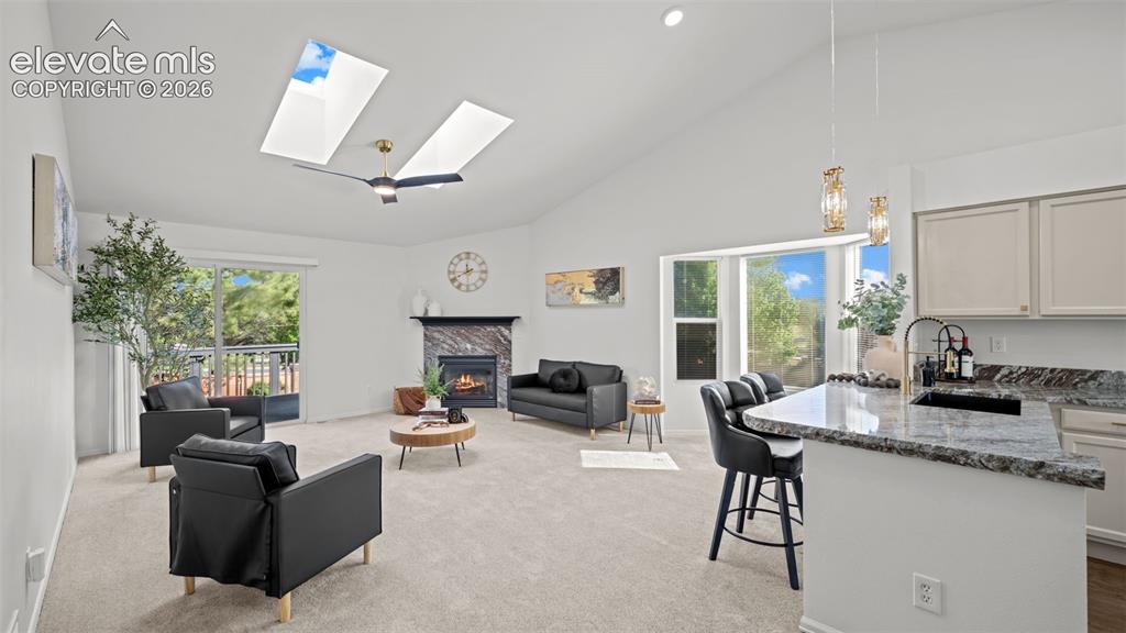 Image 5 of 46: Vaulted ceiling with dual skylights and a ceiling fan